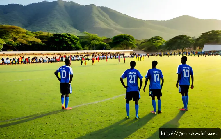 말라위에서의 축구 리그 - Photorealistic Malawi local football league match on a sunlit grass pitch, two teams in simple contr...